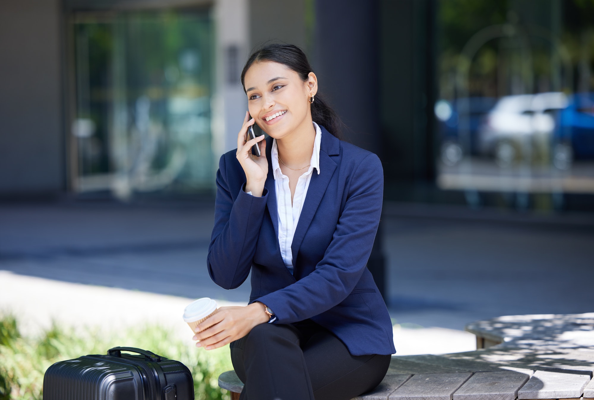 Contact, strategy and phone call by woman travel business, planning while sitting in a city on a co